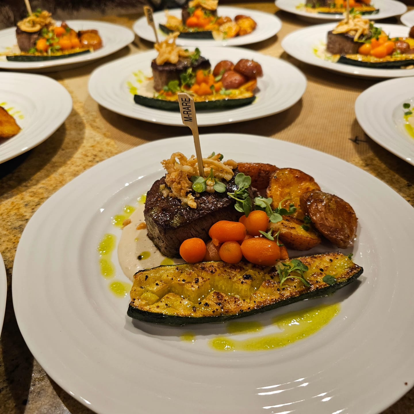 Prime Filet Mignon with Crispy Onions, Creamy Garlic Whiskey Sauce, Roasted Red Potatoes, Parisian Carrots, Roasted Zucchini